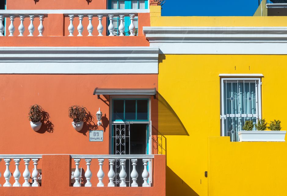 Brightly painted house facades in orange and yellow.